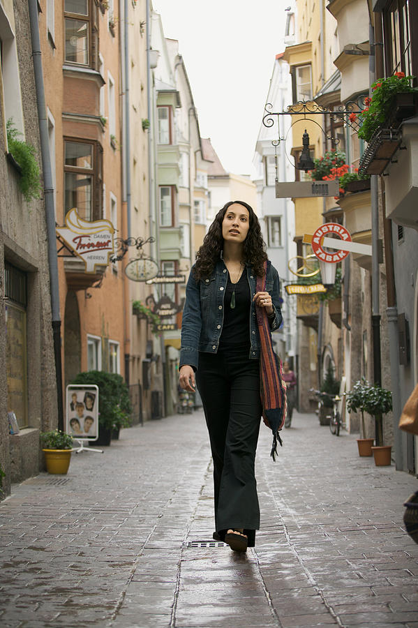 Lifestyle Portrait Of A Young Adult Woman As She Goes Sightseeing While Visiting Europe Photograph by Photodisc