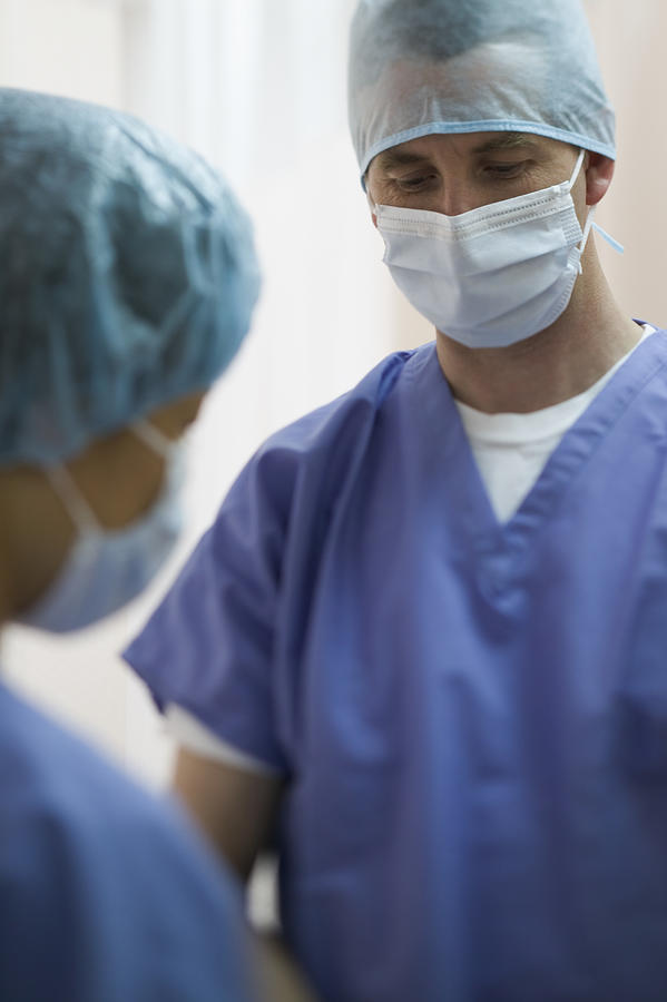 Lifestyle Portrait Of Two Adult Surgeons As They Gather Together For An Operation Photograph by Photodisc