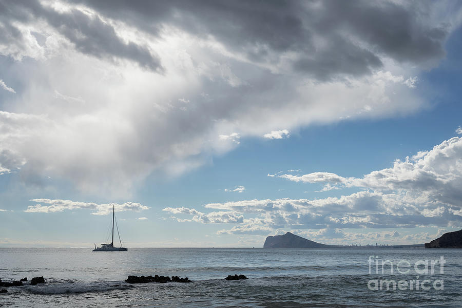 Soft clouds float over the Mediterranean Sea, seascape with sailing boat Photograph by Adriana Mueller