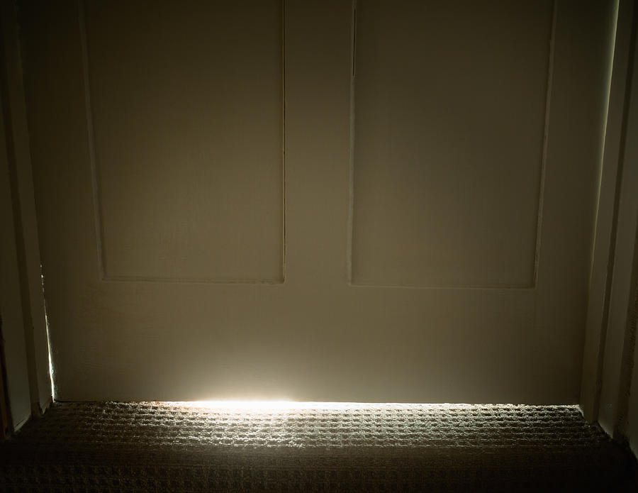 Light glowing from under door Photograph by Dan Brownsword