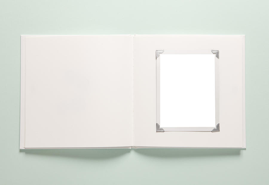Light green background with a white empty photo album Photograph by Cclickclick