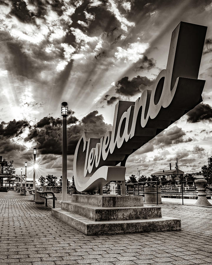Black And White Photograph - Light Rays Over The Cleveland Script Sign - Sepia by Gregory Ballos