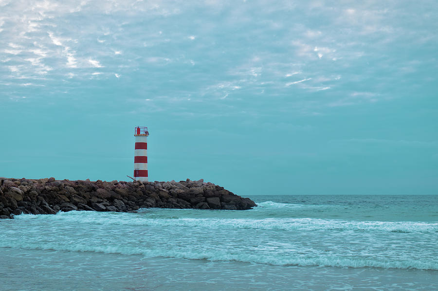 Light tower and rocks in Ilha Deserta, Algarve Photograph by Angelo DeVal