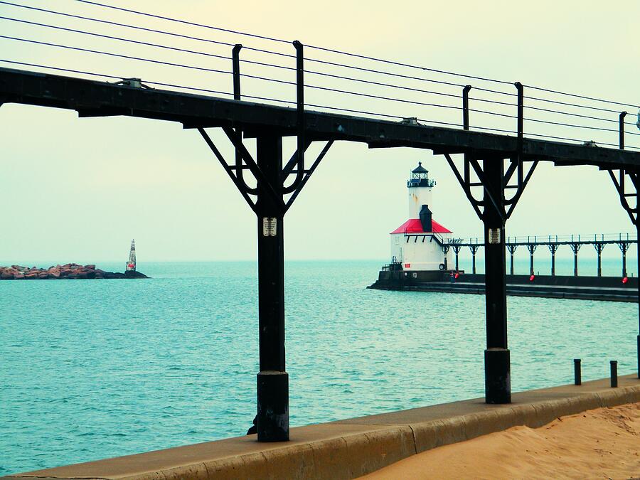 Lake Michigan Photograph - Lighthouse And Marina Beacon Seen Through Pier Catwalk   Lake Michigan     Indiana by Rory Cubel