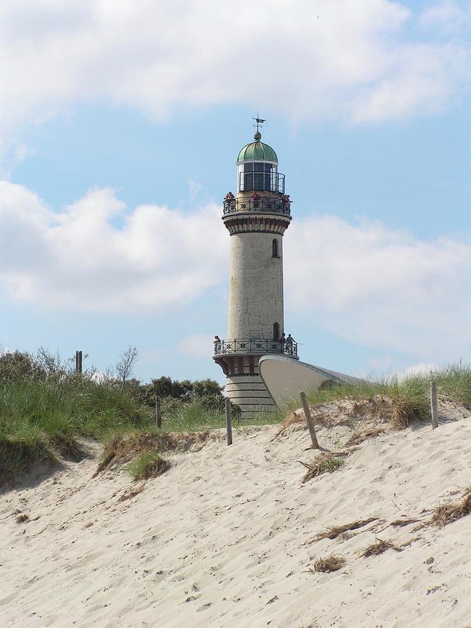 Lighthouse by the beach Photograph by Annika Farmer