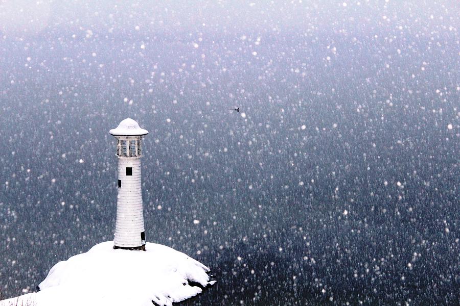 Lighthouse in snow Photograph by Donn Ingemie