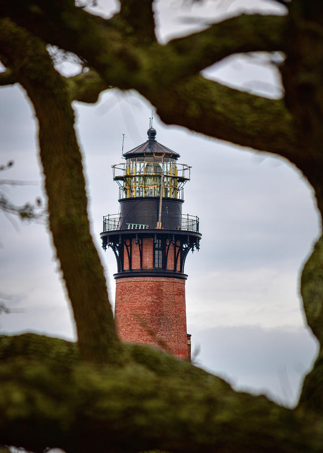 Lighthouse through the trees Photograph by Rick Nelson