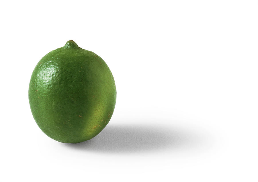 Lime, white background Photograph by Isabelle Rozenbaum