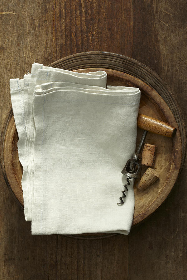 Linen napkins with corkscrew in wooden bowls. Photograph by Amy Neunsinger