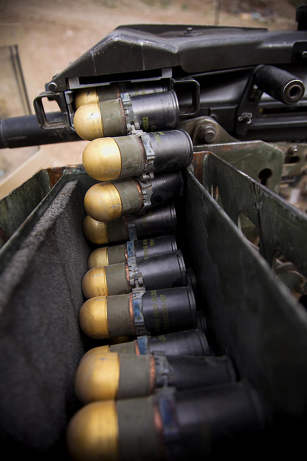 Linked 40mm rounds feed into a Mark 19 grenade launcher. Photograph by Stocktrek Images