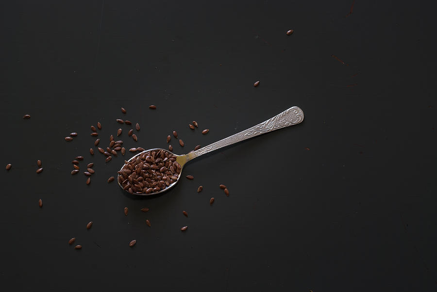 Linseed On Metal Spoon On Dark Wooden Table Photograph by MichalDziedziak