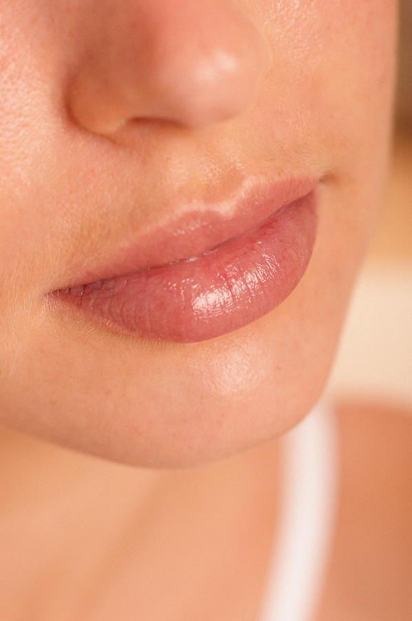 Lips of young woman Photograph by Image Source