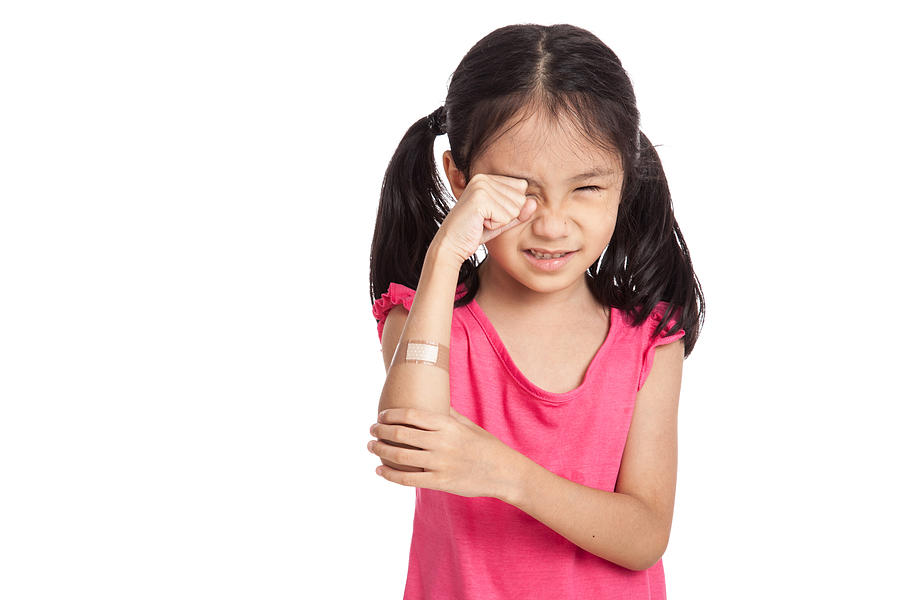 Little asian girl  hurt with bandage on her arm Photograph by Halfbottle
