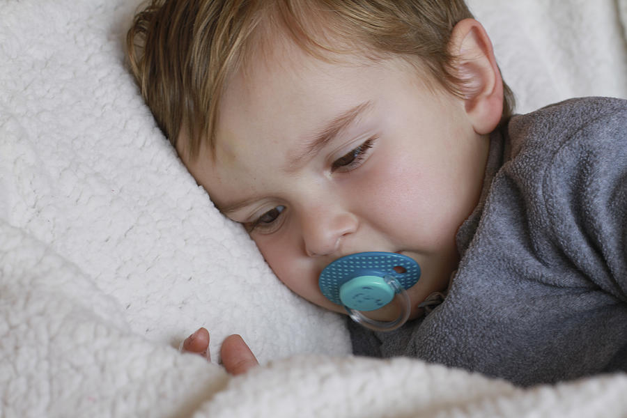 Little baby boy with pacifier on bed Photograph by Isabel Pavia