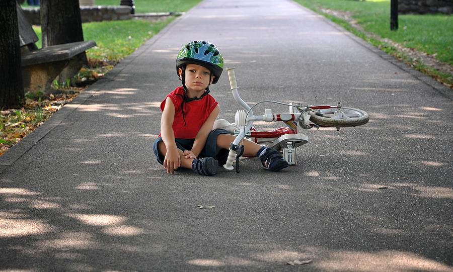 Little boy falling off bicycle Photograph by Edoardo Frola