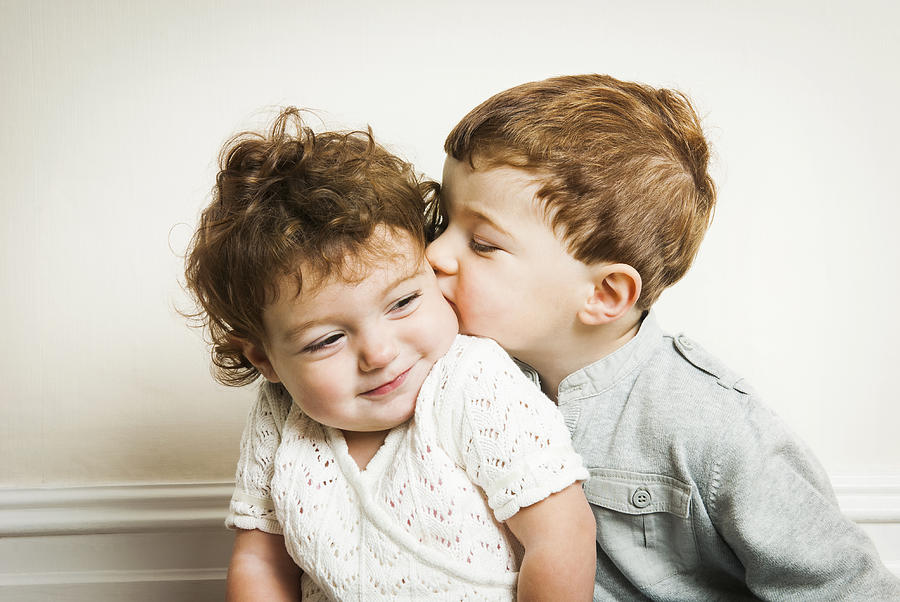 Little boy kissing little girl. Photograph by Matthew Wreford