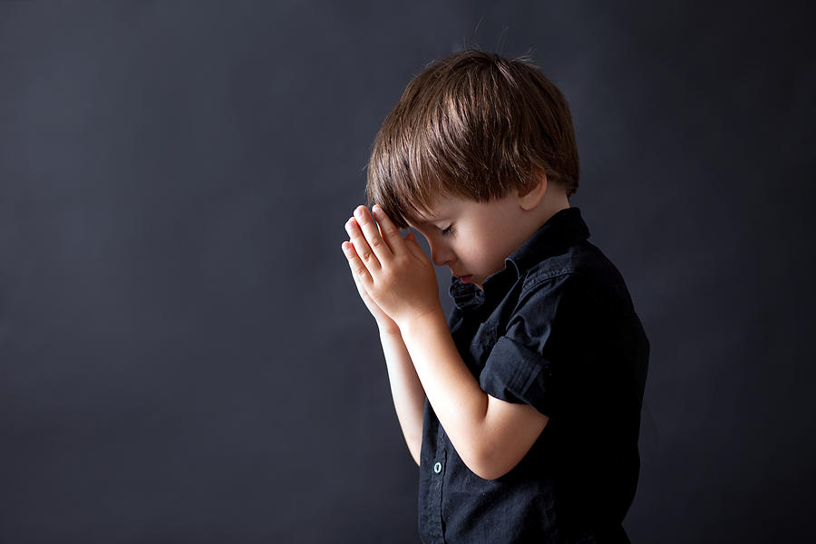 Little boy praying, child praying, isolated background Photograph by Tatyana_tomsickova