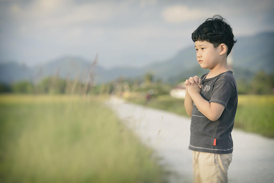 Little boy praying outdoor Photograph by Jordan Lye