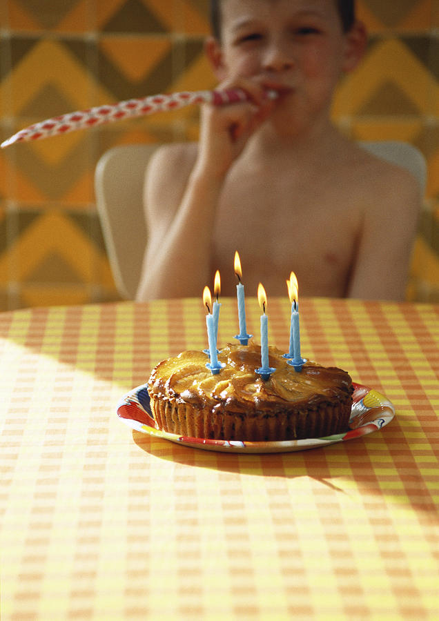 Little boy with birthday cake. Photograph by Mieke Dalle
