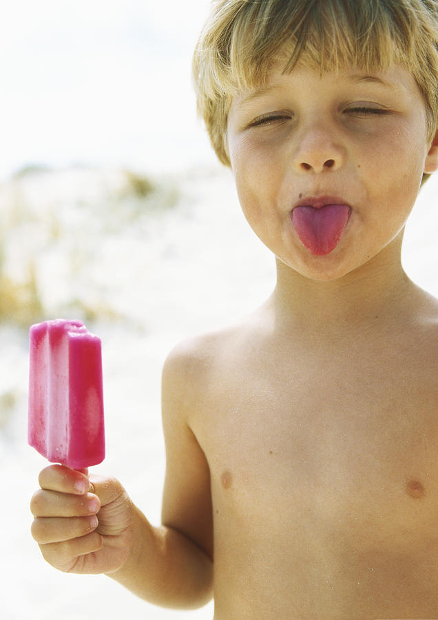 Little boy with popsicle, sticking tongue out with eyes closed Photograph by Sigrid Olsson