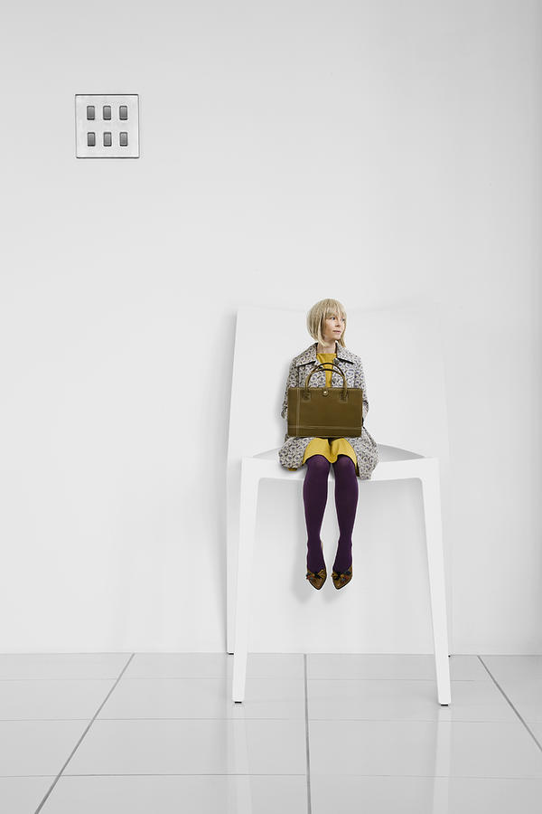 Little businesswoman waits in a giant office chair Photograph by Andrew Bret Wallis