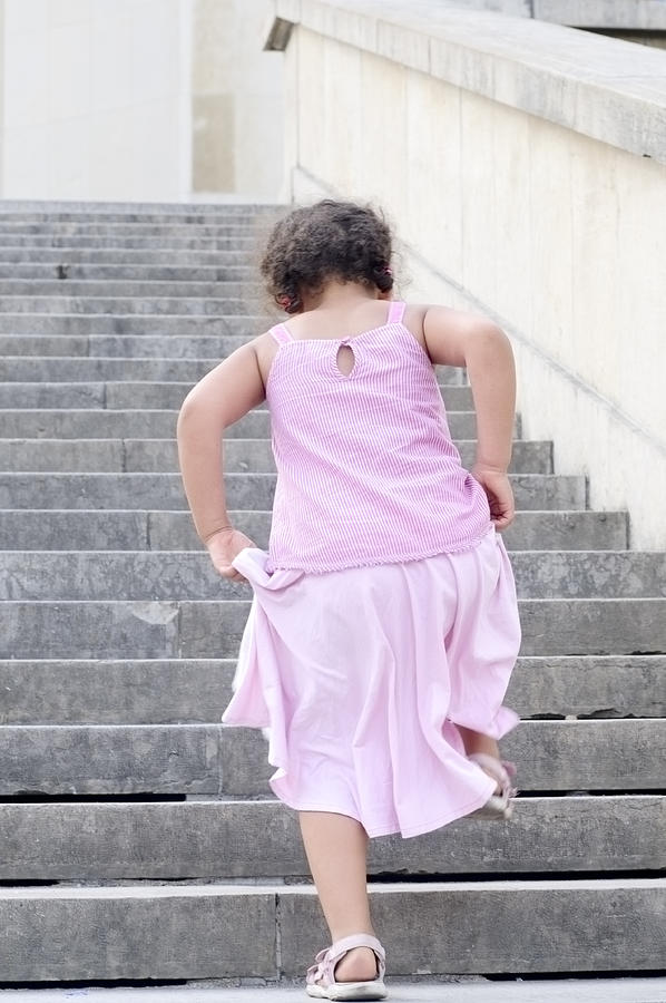Little Girl (5-6) Climbing Stairs Outdoors, Horizontal Photograph by Onebluelight