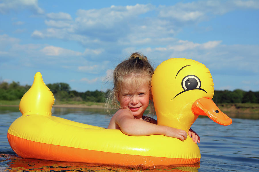 Little Girl Bathes In River In Inflatable Duck Photograph by Mikhail Kokhanchikov