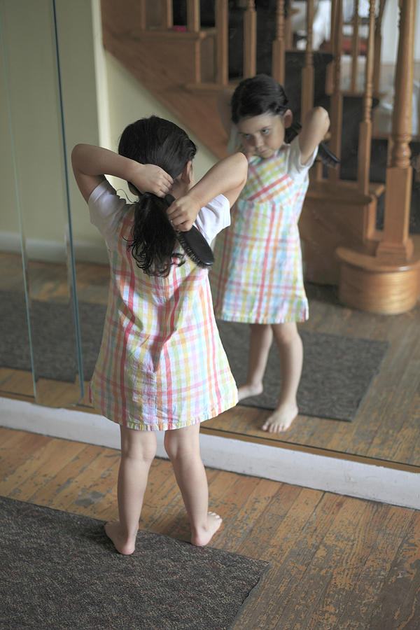 Little girl brushing hair Photograph by Wendy Connett