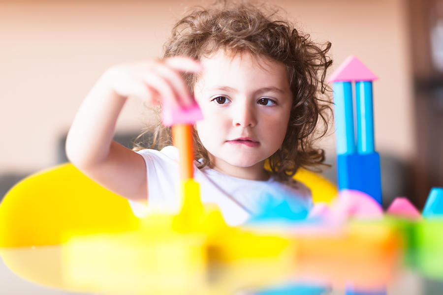 Little girl building a house with cubes Photograph by LaraBelova