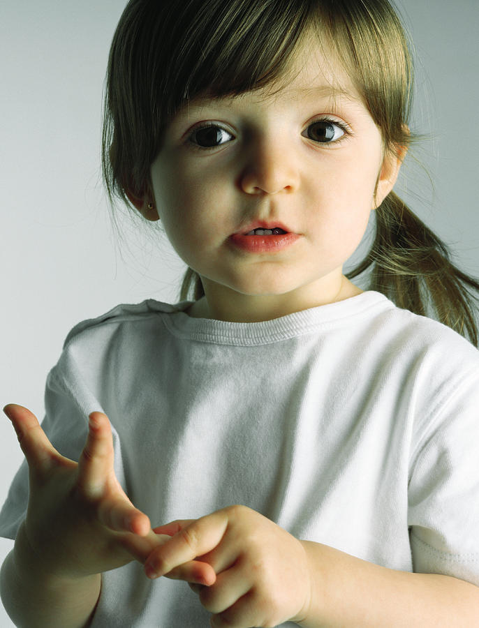 Little girl counting with her fingers, looking at camera, portrait Photograph by PhotoAlto/Michele Constantini