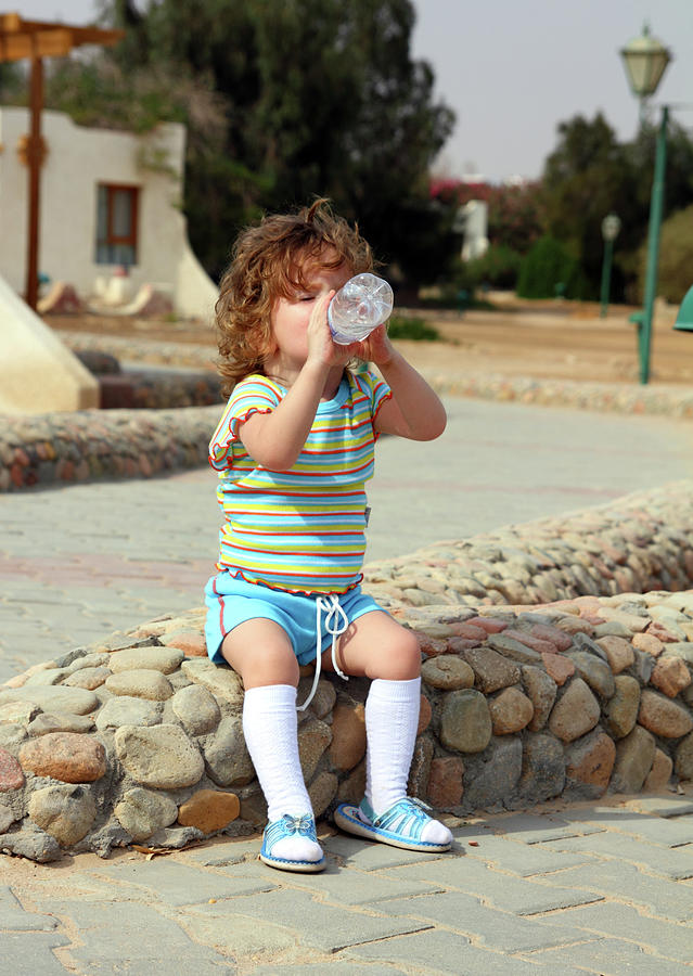 Little Girl Drinking From Bottle Photograph by Mikhail Kokhanchikov