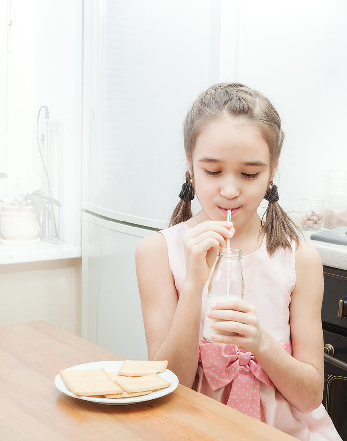 Little girl drinking milk Photograph by Salima Senyavskaya