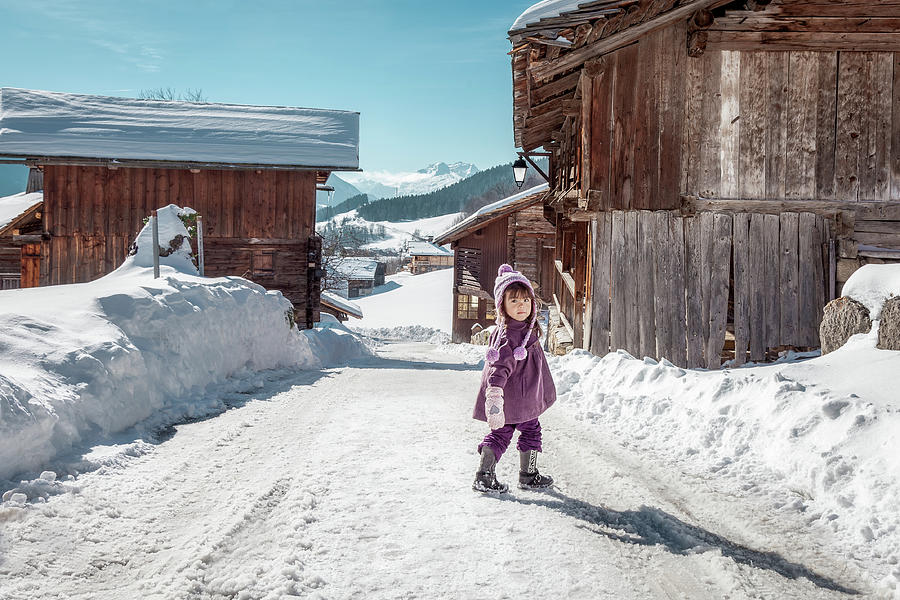 Little girl enjoying snow in Le Grand-Bornand French alps ski re Photograph by Benoit Bruchez