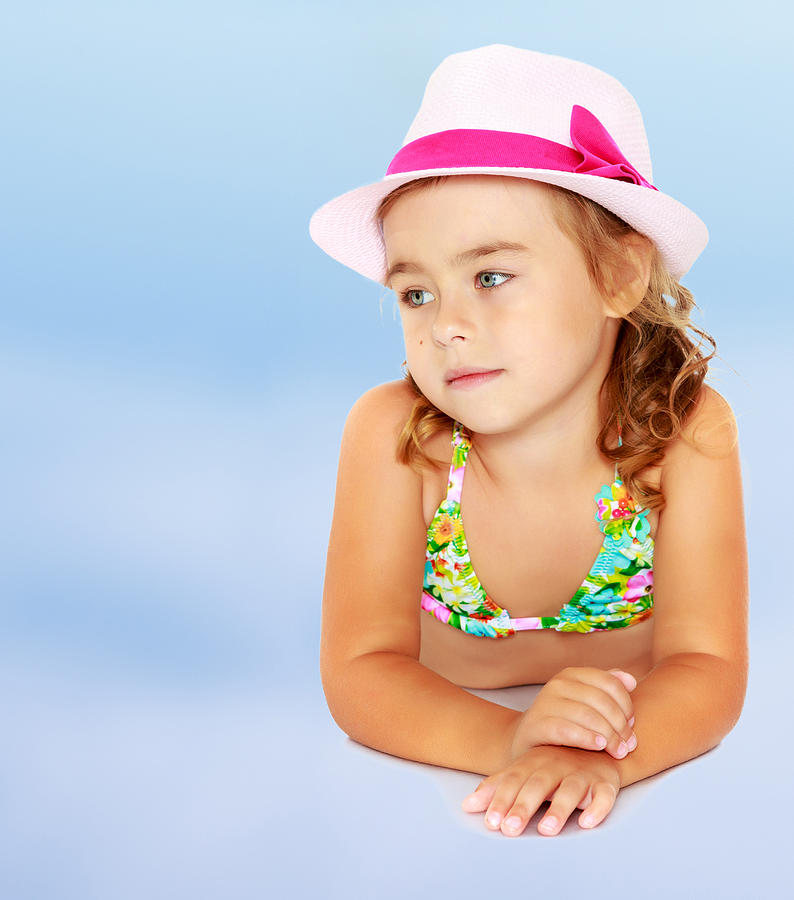 Little girl in swimsuit and hat. Photograph by Lotosfoto