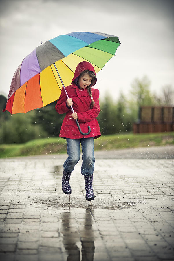 Little girl jumping in the rain Photograph by Imgorthand