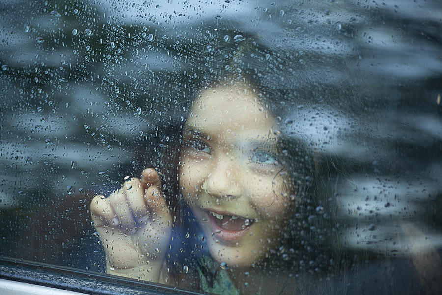 Little girl looking out of car window Photograph by IndiaPix/IndiaPicture