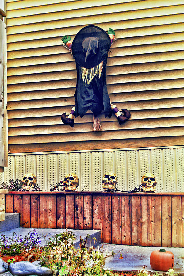 Little Halloween witch stuck on a wall Photograph by Tatiana Travelways
