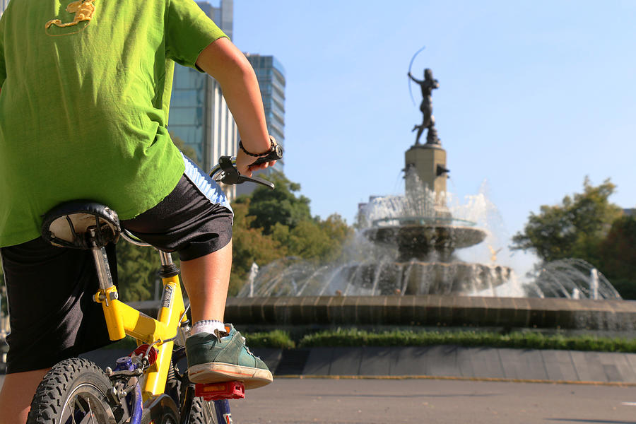 Little kid participating in a bicycle tour in Mexico City, Mexico - Diana Cazadora Fountain Photograph by Tais Policanti