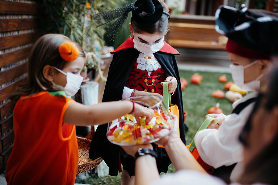 Little kids at a Halloween party Photograph by Anchiy