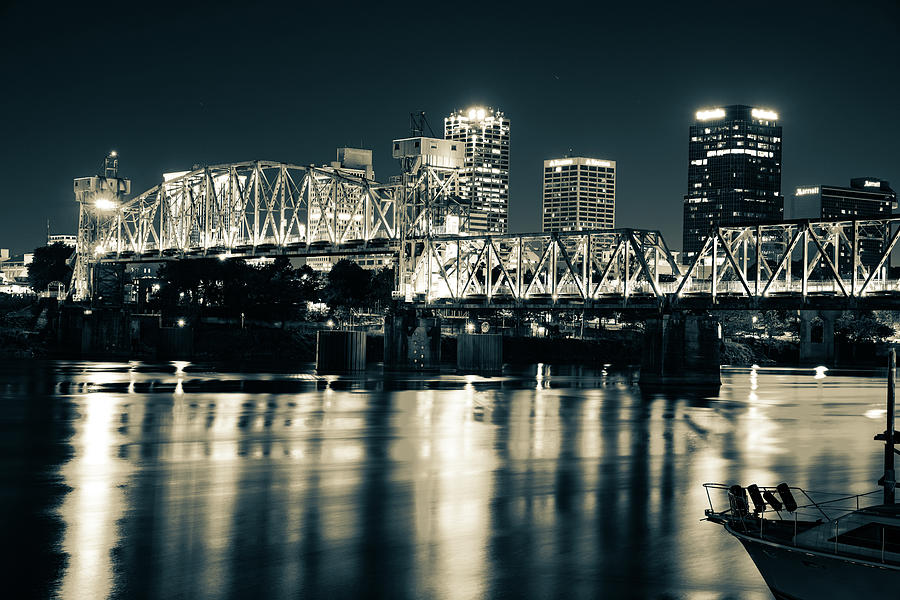 Little Rock Radiance - Illuminated Junction Bridge and Vibrant Downtown Skyline In Sepia Photograph by Gregory Ballos