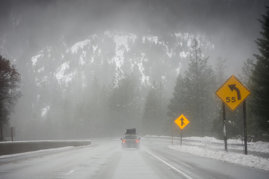 Loaded up family car on snowy Pacific Northwest road trip Photograph by Bradleyhebdon