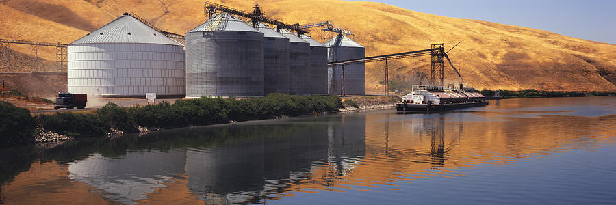 Loading grain on barge on Snake River Photograph by Timothy Hearsum