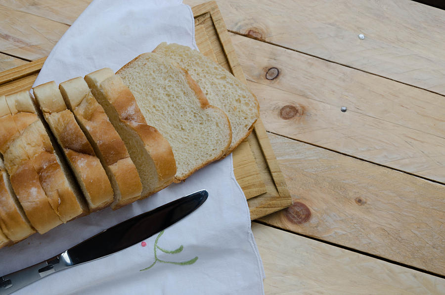 Loaf of sliced bread on a chopping board Photograph by Elizabeth Fernandez