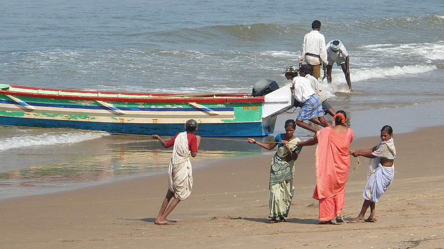 Local fishermen push their fishing boats ashore in Gokarna, Karnataka, India Photograph by Photo by Victor Ovies Arenas