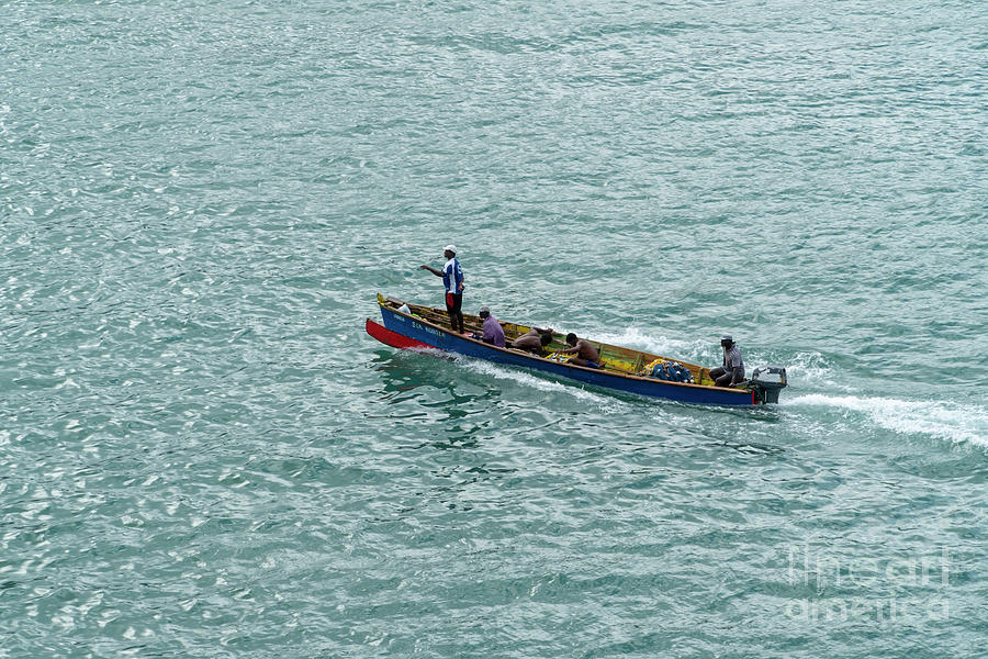 Local fishermen work in a small boat in the harbor and port of C Photograph by William Kuta