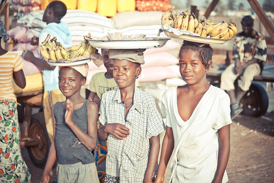 Local girls selling bananas. Photograph by Peeterv