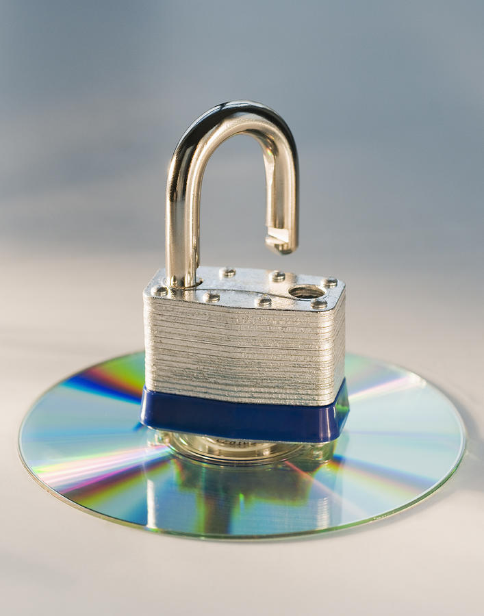 Lock and compact disc Photograph by Daniel Grill