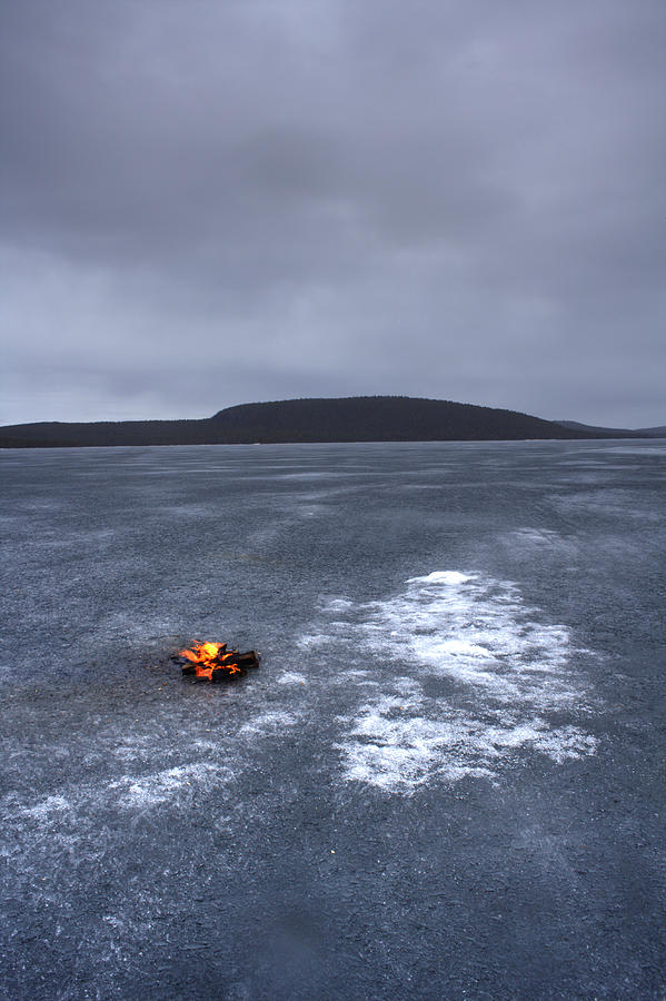 Log fire burning on frozen lake Photograph by Simon Bottomley