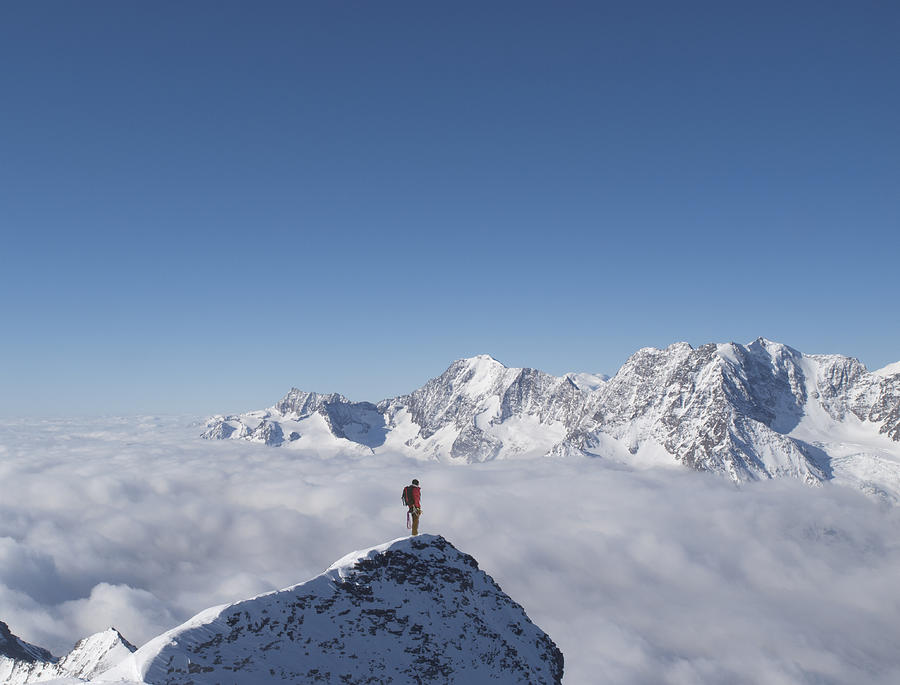 Lone climber on top of a snowy peak Photograph by Buena Vista Images