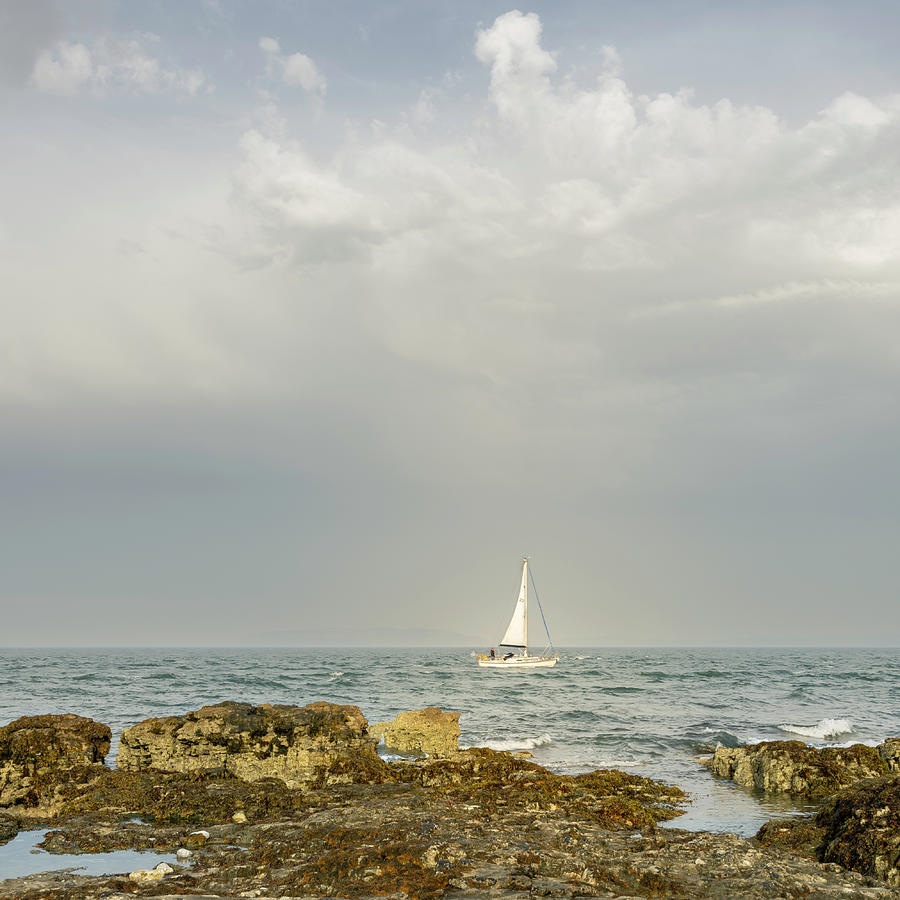 Lone Sailor at Penmon Point Photograph by Spikey Mouse Photography